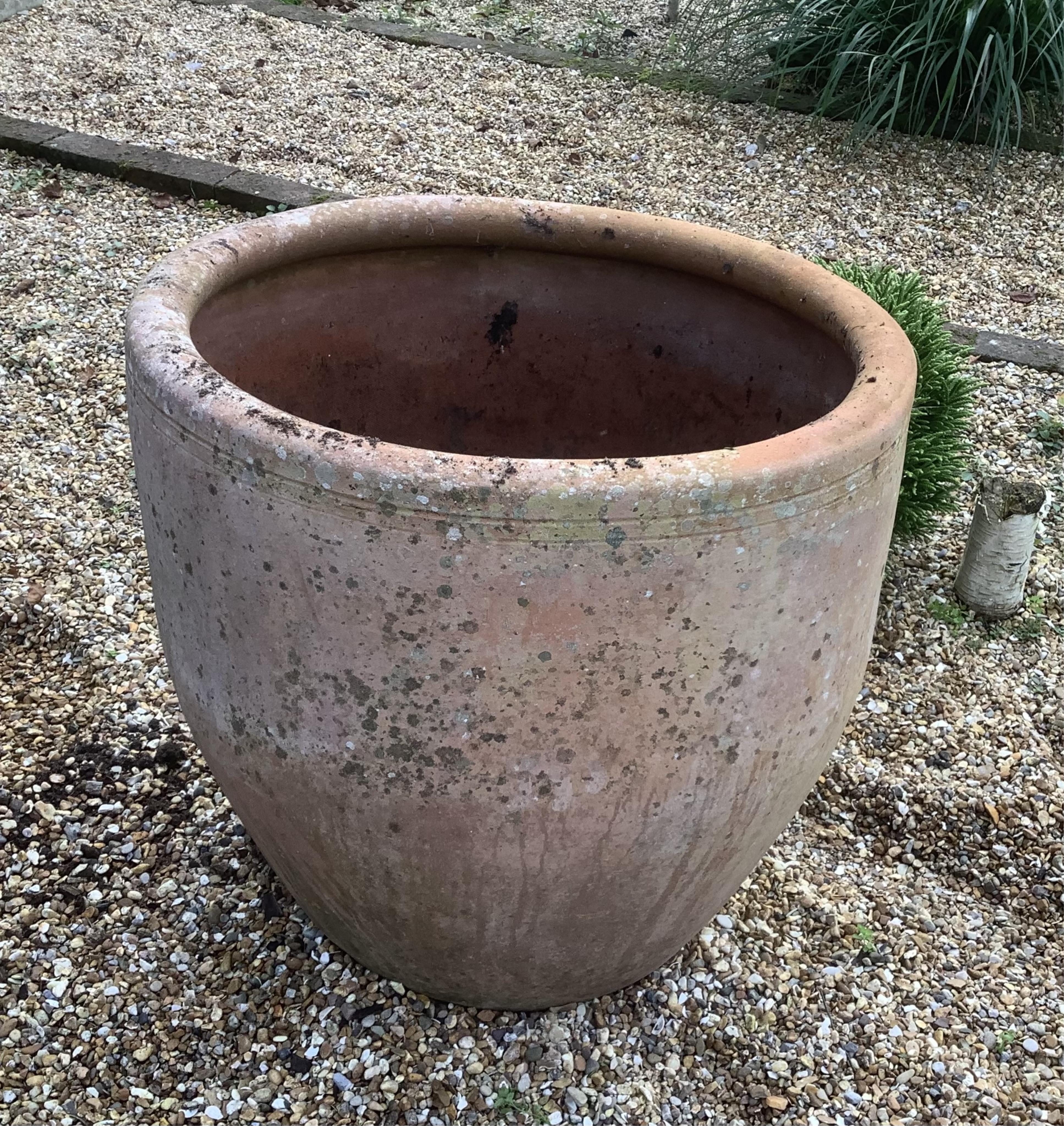 A pair of large terracotta planters, height 72cm, width 62cm. planting removed. Condition - weathered, otherwise good